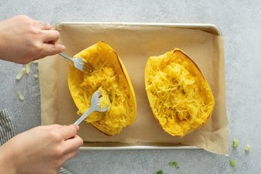 Pulling threads of spaghetti squash with two forks