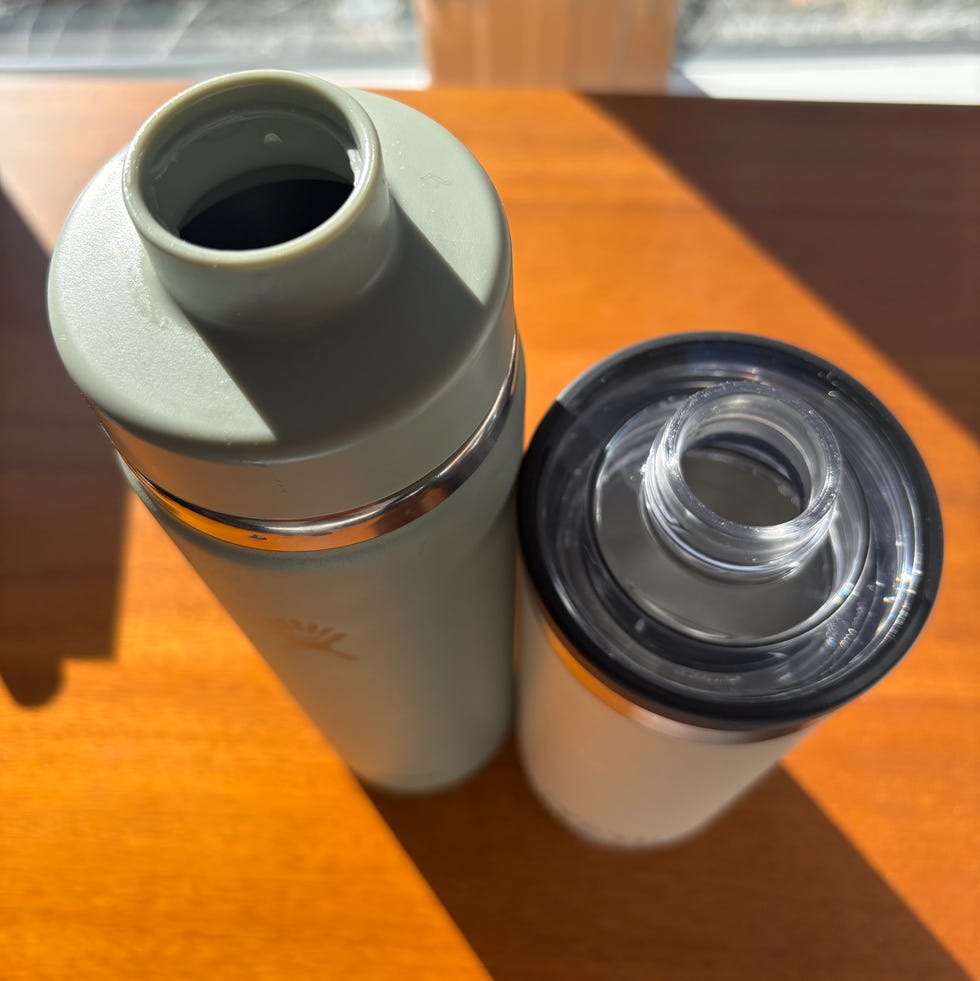two thermos bottles on a wooden surface