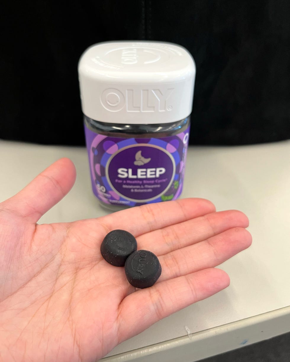 sleep supplements in hand next to a container