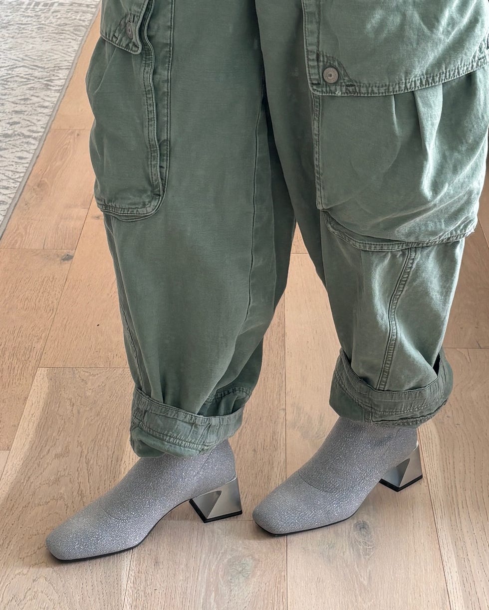 casual outfit featuring green cargo pants and gray socks with heels on wooden floor