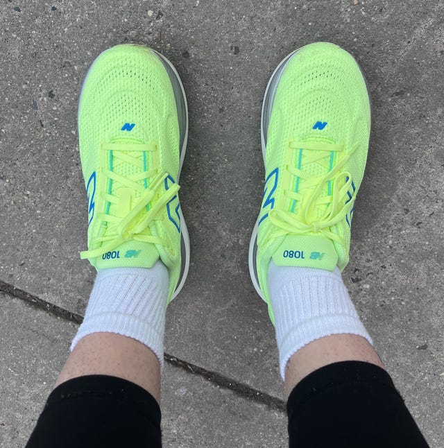 Brightly colored running shoes on a concrete surface.