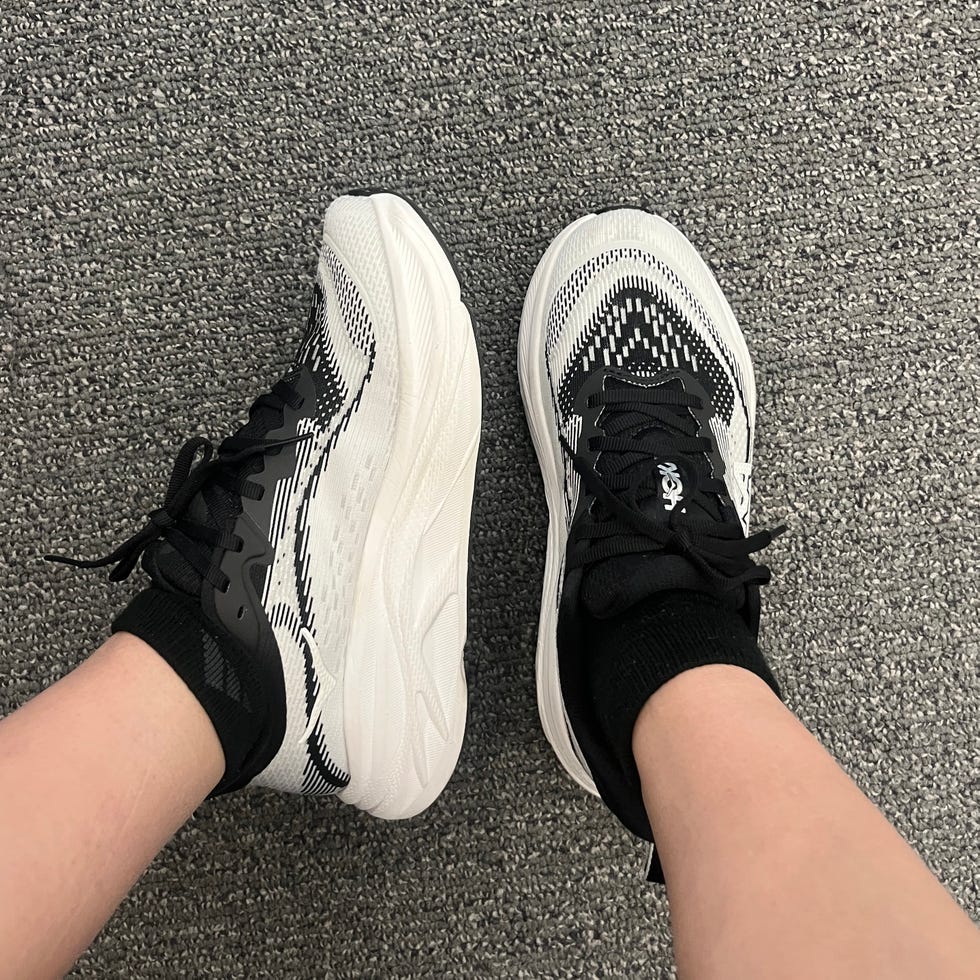 Footwear featuring a black and white design on a textured floor.