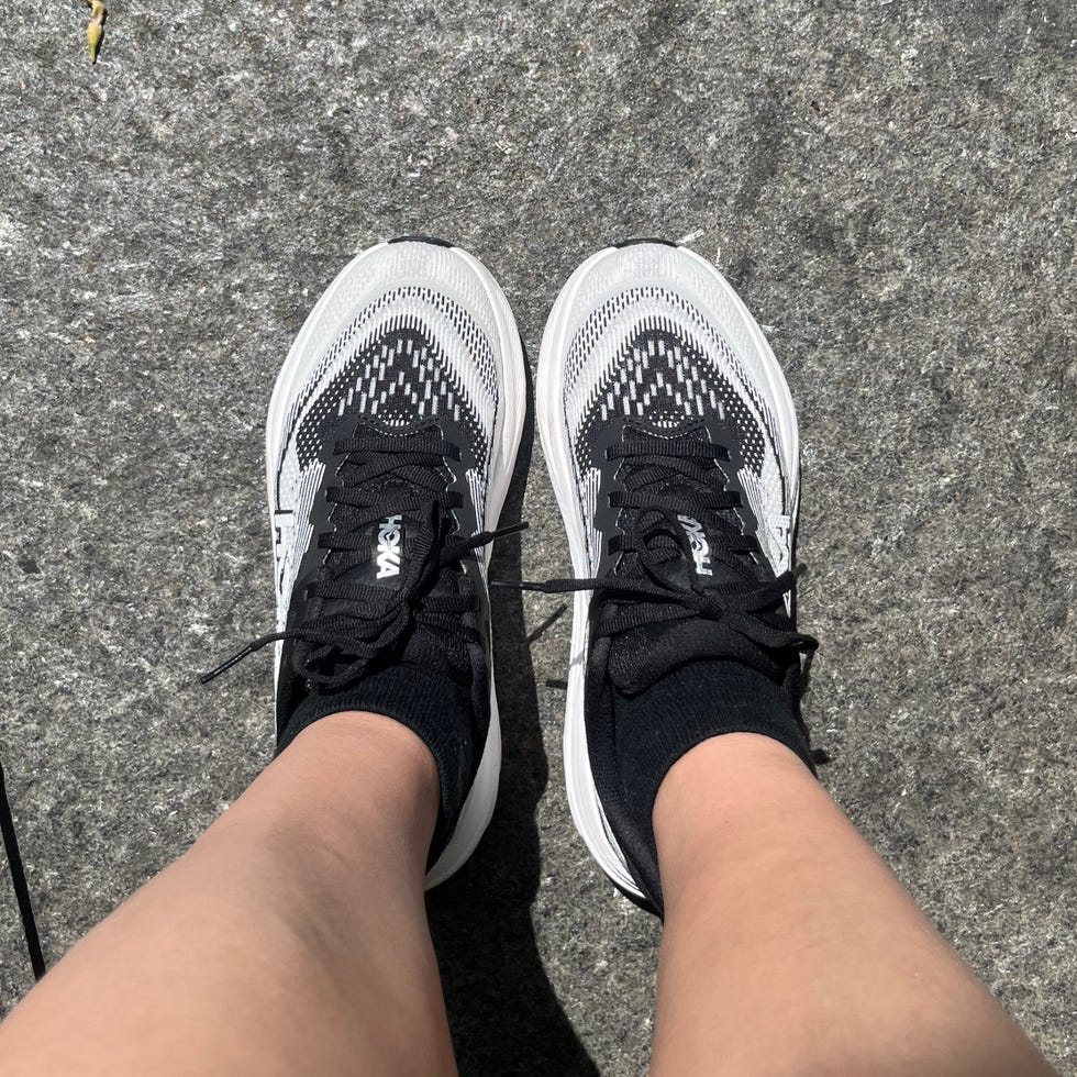 Athletic footwear with a distinct design on a concrete surface.