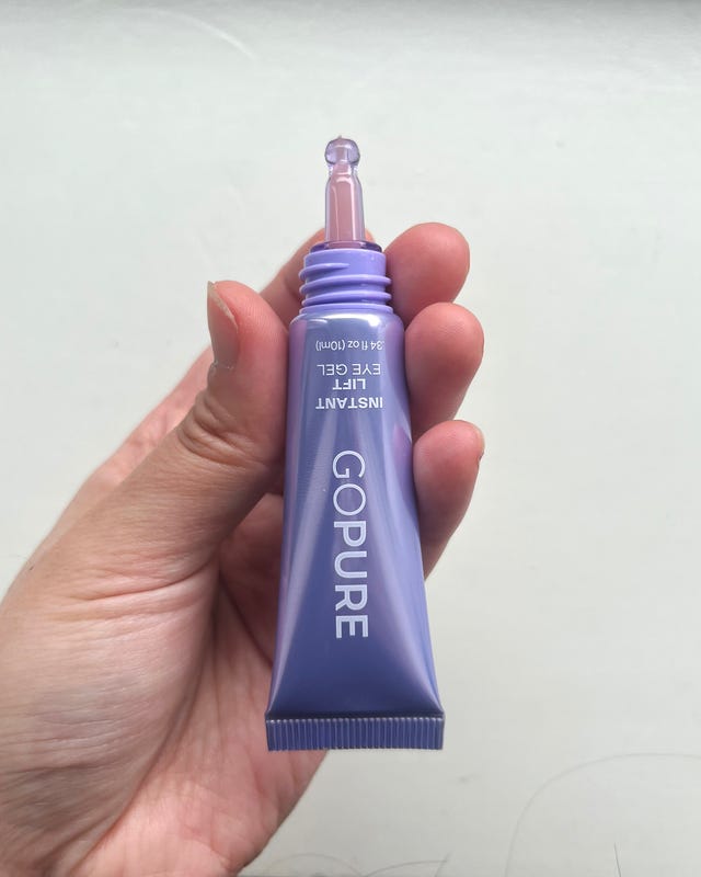Instant eye gel tube held in a hand.