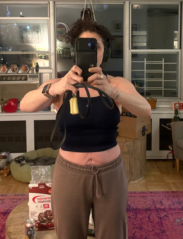 Self-portrait of a person in a living room setting.