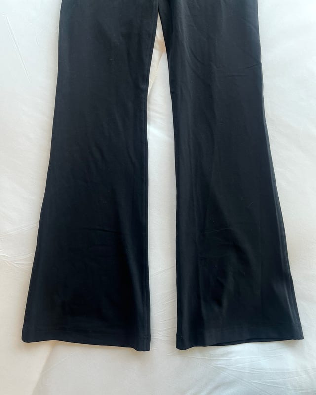 Black flared pants on a white background.