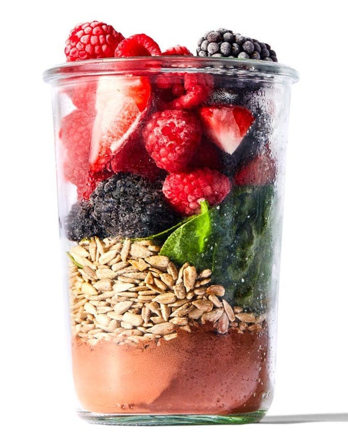 layered smoothie ingredients in a glass jar