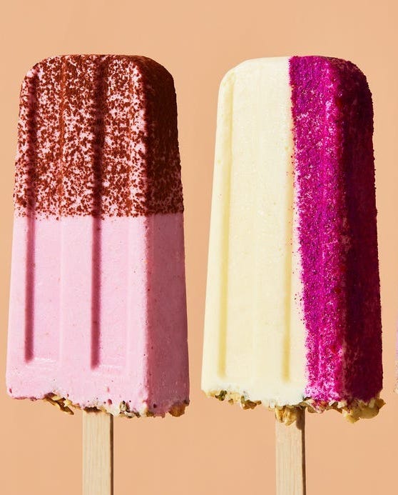 two colorful popsicles on wooden sticks