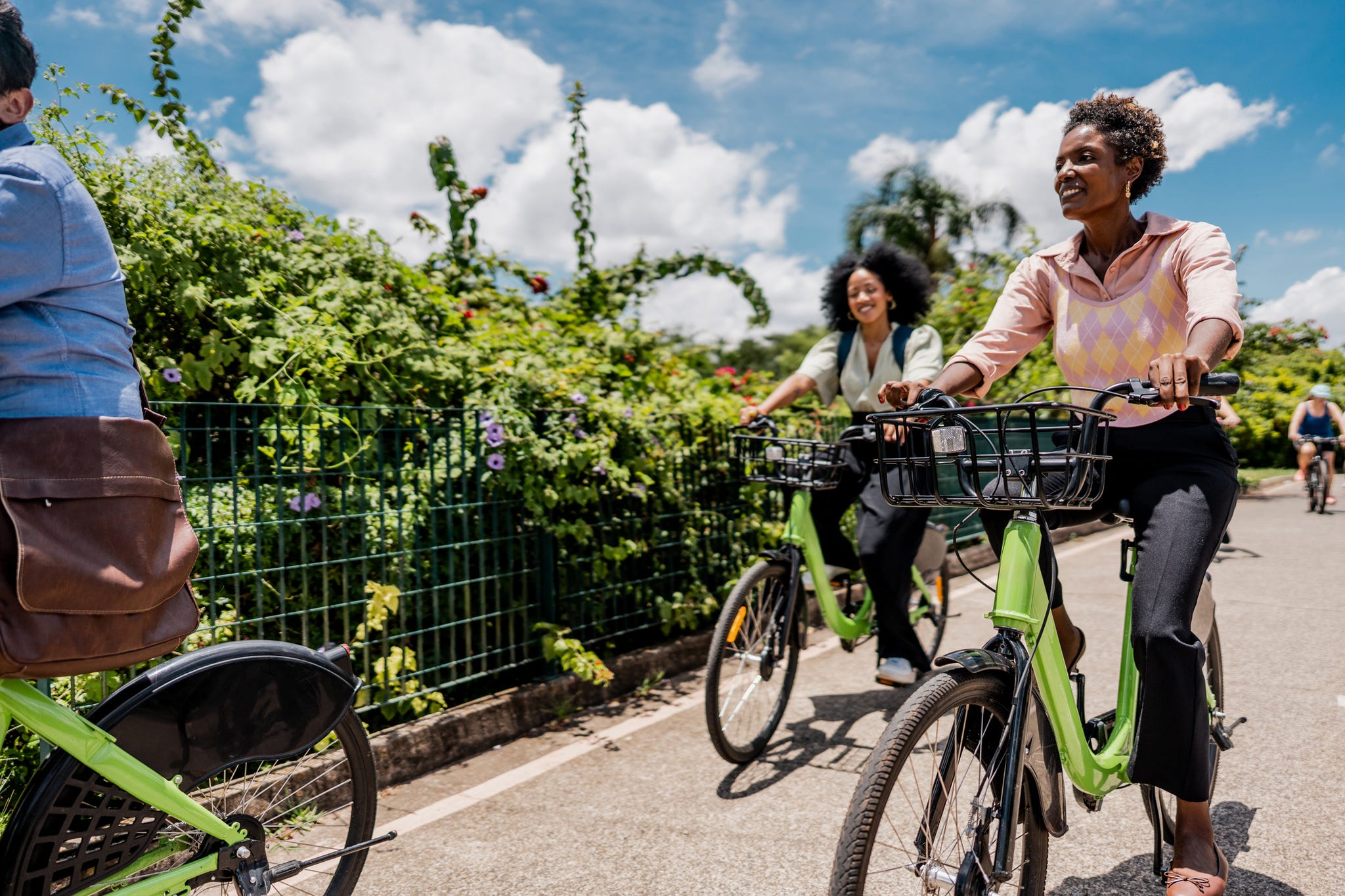 coworkers riding a bicycle at public park