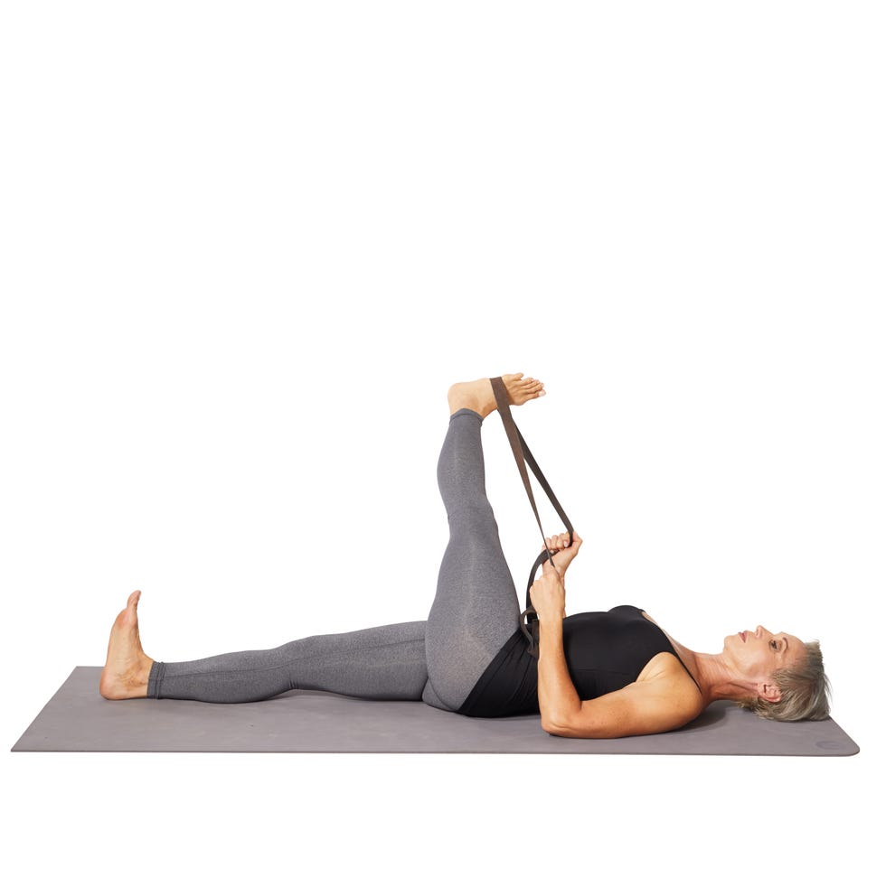 woman doing it band stretch on the floor