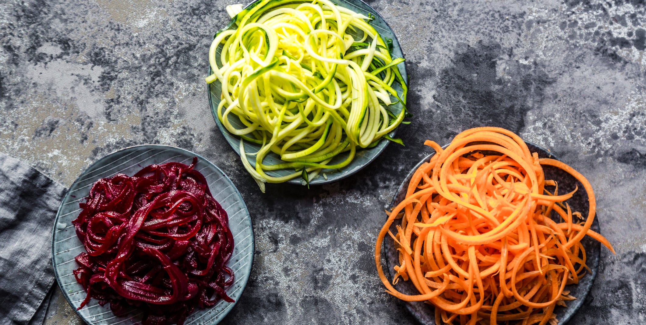 Bowl of Zoodles and bowls of carrot and beetroot spaghetti