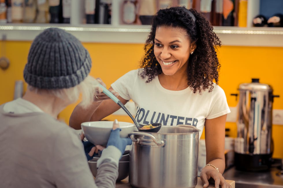 being a volunteer nice friendly woman smiling while enjoying her job as a volunteer