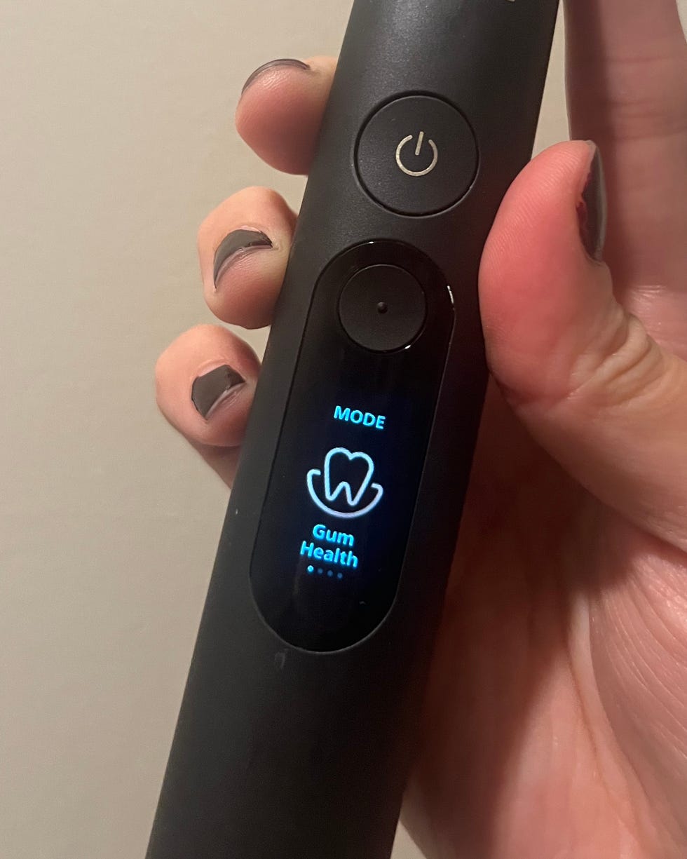 Sonic toothbrush featuring a mode button displaying "Gum Health" setting.