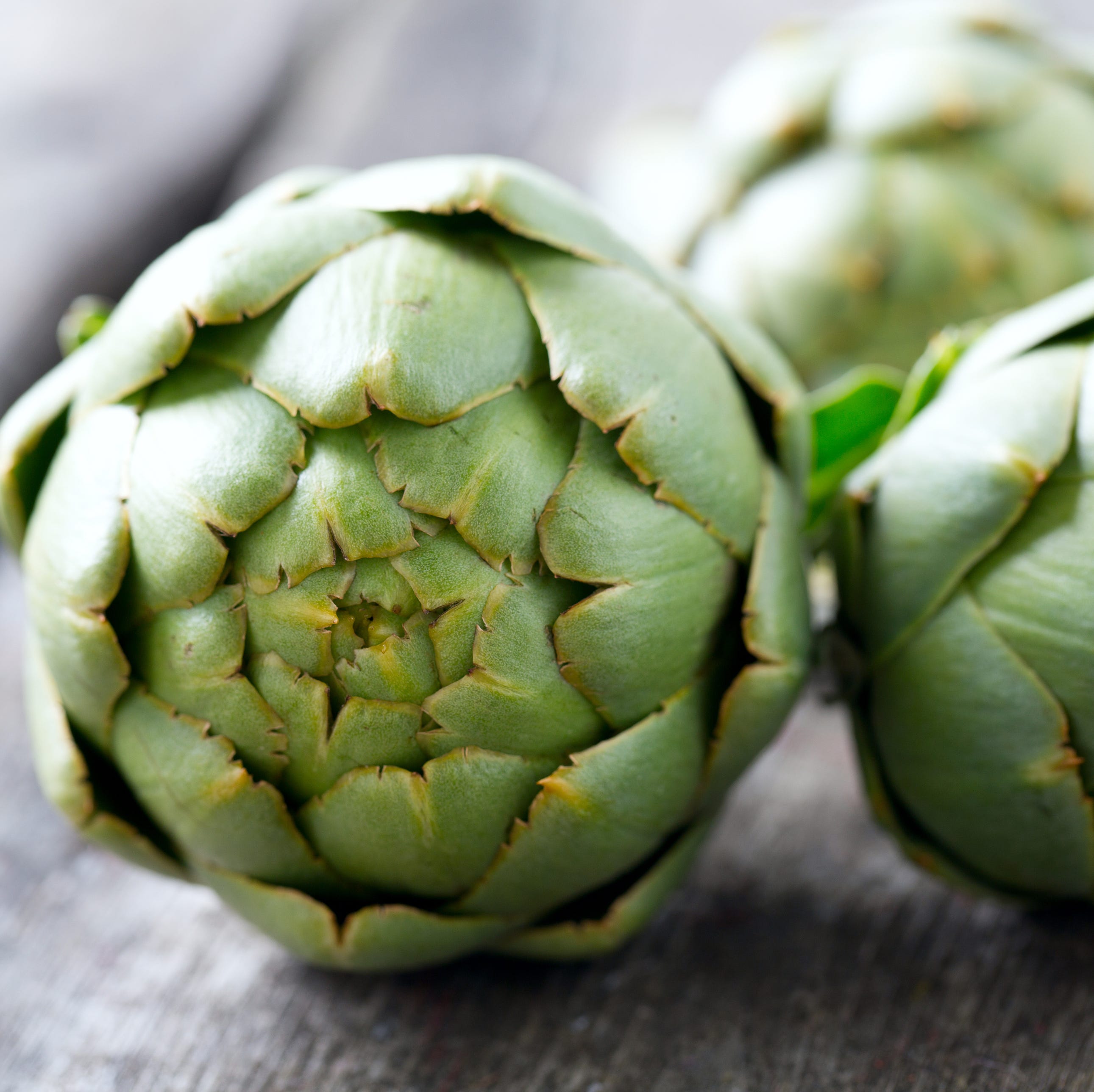 artichokes on wooden surface