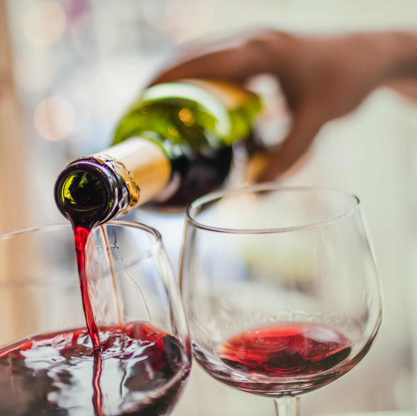 Pouring red wine in glasses